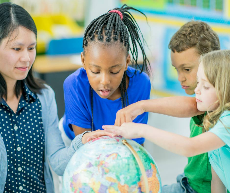 Children looking at an earth globe